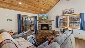 A cozy living room with a fireplace, grey sofas, and a wooden ceiling. - Embers Place - Murphy (Murphy)