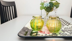 A table with two glass vases and a candle holder. - 4 Star Holiday Home in Skanderborg (Skanderborg)