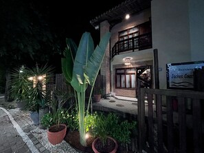 A two-story building with a balcony, potted plants, and a sign indicating 'Residence'. - Apartment 400m from Praia do Francês Beach/AL (Marechal Deodoro)
