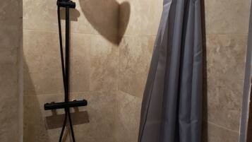 Shower, hair dryer, soap, toilet paper