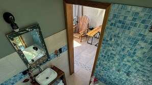 A bathroom with a bathtub, toilet, sink, and a mirror.