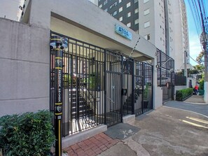 A gated entrance to a building with a sign reading "ATUA".