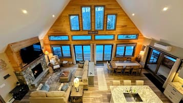 TV connectée, cheminée, livres, écrans d'ordinateur