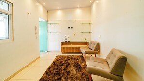 A modern living room with a sofa, a coffee table, and a rug.