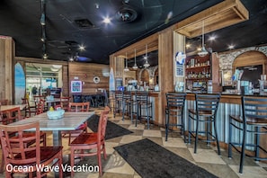 A restaurant interior with wooden decor, a bar area, and multiple seating options.