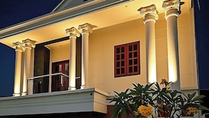 A two-story house with a balcony, columns, and a gated entrance. - KOSTEL H88 (Depok)