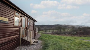 A wooden building with a sign reading "Colonsay Lochaber Lodges."