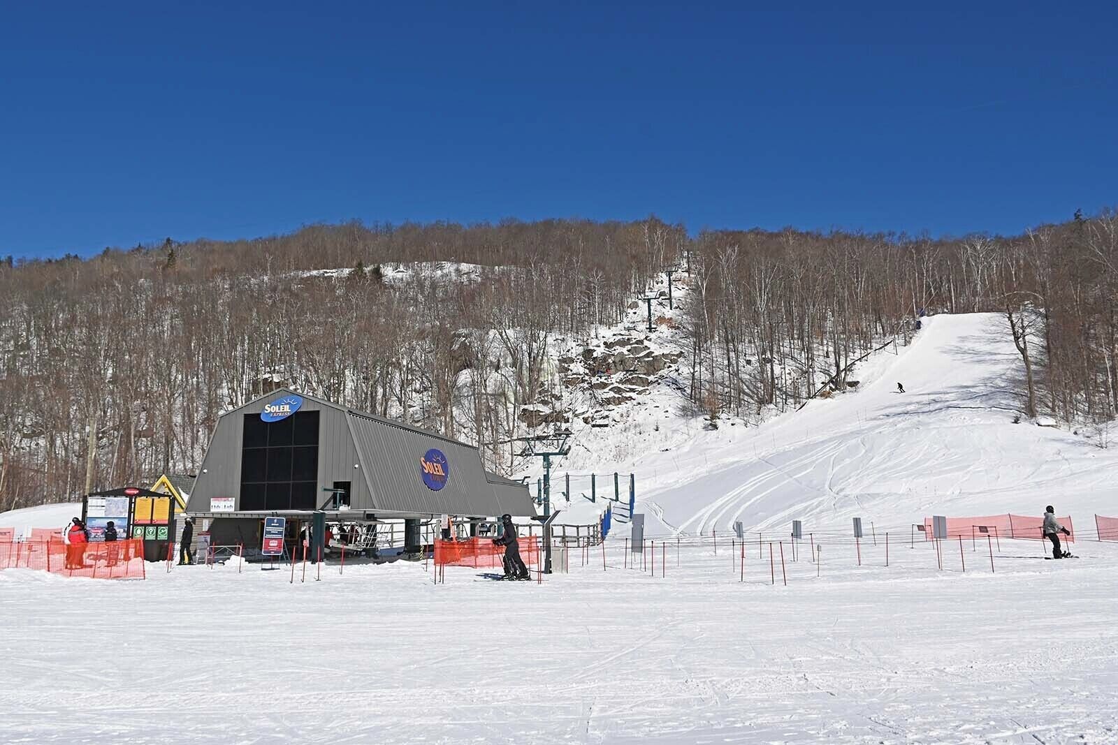 A ski resort with a large building labeled 'Ski' and a ski slope in the background.