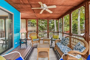 A covered porch with wicker furniture, a ceiling fan, and a view of trees. - Relaxing Bayside Retreat in South Bethany w/ Porch, Bikes & Beach Access (South Bethany)