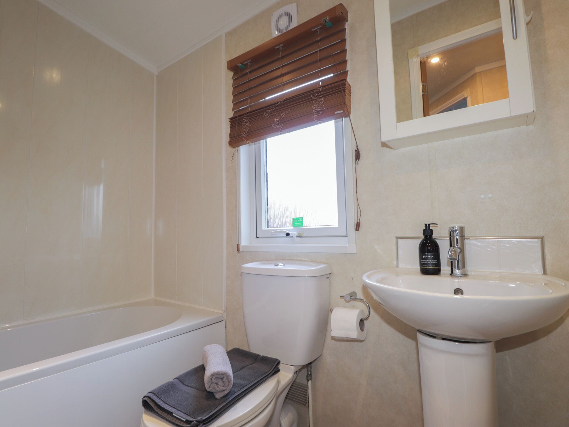 A bathroom with a bathtub, toilet, and sink.