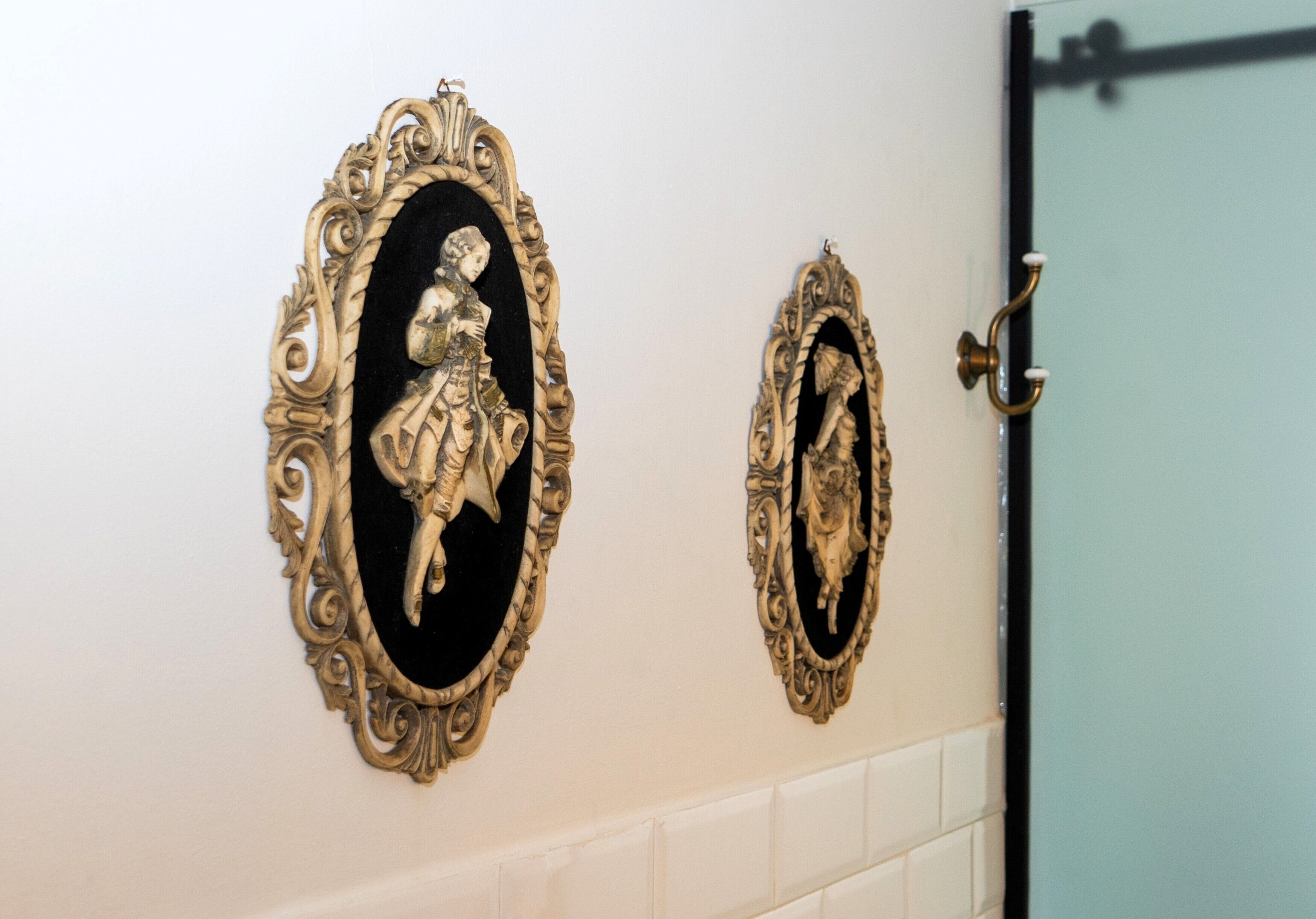 Two ornate wall-mounted mirrors with intricate designs.