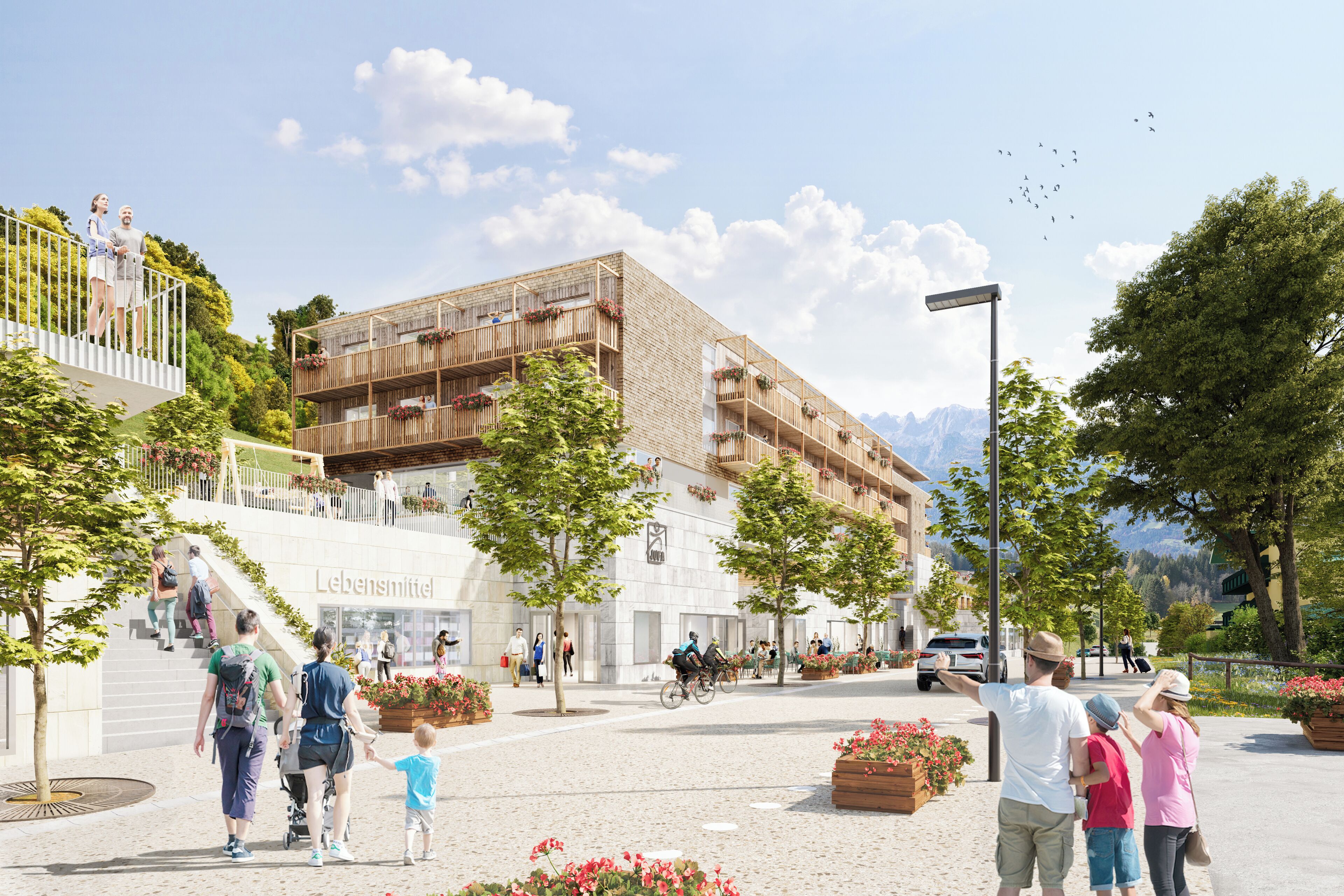 Un bâtiment moderne doté de nombreux balcons, d’un escalier central et d’un espace paysager aménagé avec des arbres et des parterres de fleurs.