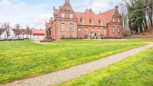 A large brick building with multiple windows and a prominent tower. - 4 Star Holiday Home in Skanderborg (Skanderborg)