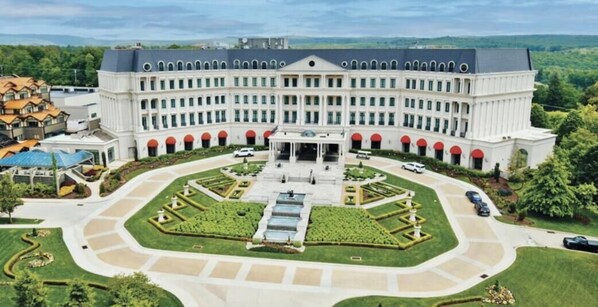 A large, symmetrical building with a central entrance, surrounded by a well-manicured garden and a parking area. - Updated in 2026 Barrel Sauna/Hot Tub, GameRoom (McHenry)