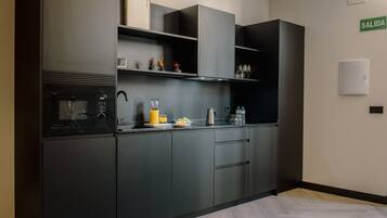 Een microgolfoven, een broodrooster, kookgerei, borden en bestek