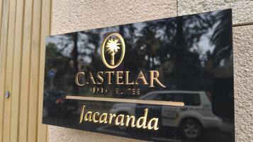 A sign for Castelari Urban Suites Jacaranda.