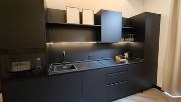 Microwave, toaster, cookware/dishes/utensils, dining tables