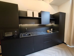 Microwave, toaster, cookware/dishes/utensils, dining tables