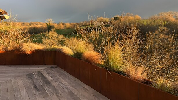 A wooden deck with a metal railing overlooking a grassy landscape with trees. - Holiday Home “Le Pentadou – Gîte Lou Costalou” with Pool, Private Terrace & Wi-Fi (Felzins)