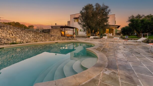 A modern house with a swimming pool, stone walls, and outdoor seating. - Fantastic pool villa w/ private park 2km from sea (Castro)