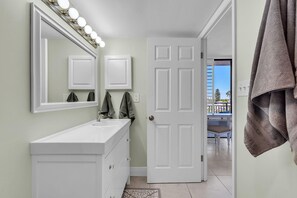 A bathroom with a vanity, mirror, and lights. - Mansions By The Sea 306a - Premier (Treasure Island)