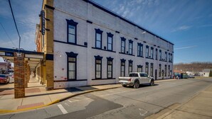 A white building with multiple windows and a brick facade. - The Downtown Post (Elizabethton)