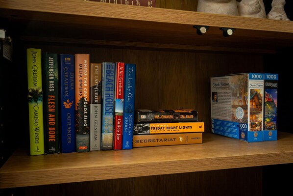 A bookshelf with various books and a puzzle box.