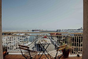 A balcony with a view of a marina and a cityscape. - Endless Charm by Monholiday (Monopoli)