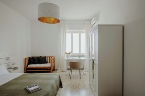 A bedroom with a bed, a desk, a chair, and a wardrobe. - Endless Charm by Monholiday (Monopoli)