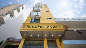 The exterior of Hotel Vindhya Inn with a modern design, featuring a prominent sign and multiple balconies. - KDSON Vindhya Inn (New Delhi)