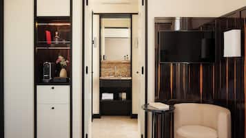 A modern room with a wardrobe, a vanity with a mirror, and a television.