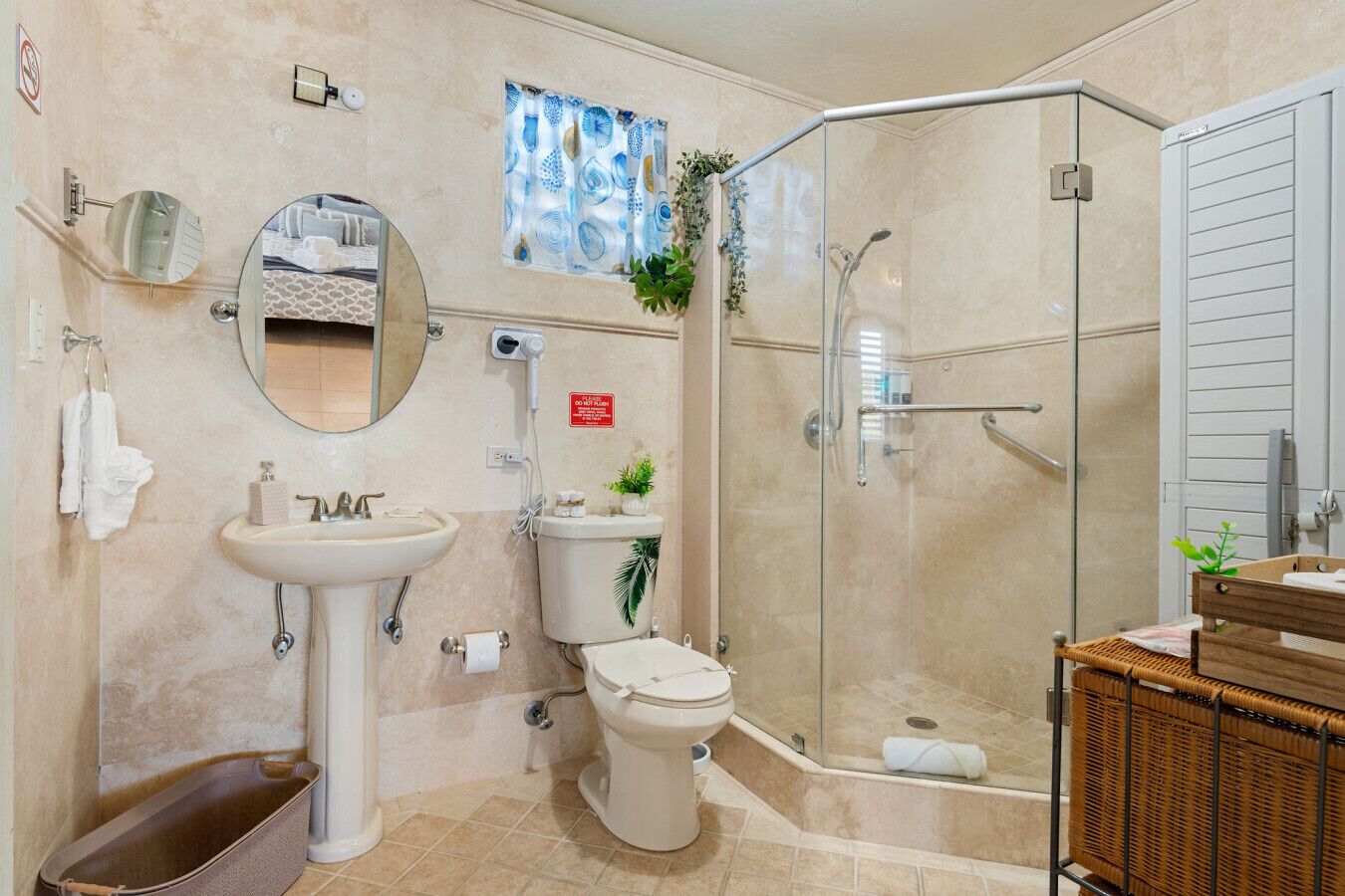 A bathroom with a sink, toilet, and glass-enclosed shower.