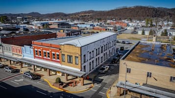 A downtown area with a mix of commercial buildings, including a prominent red and blue building with a flat roof.