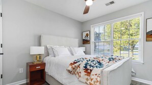 A bedroom with a bed, nightstand, and window with blinds. - Georgetown Getaway, Sleeps 6, Fenced Yard (Pet-Friendly), Near Lexington & I-75 (Georgetown)