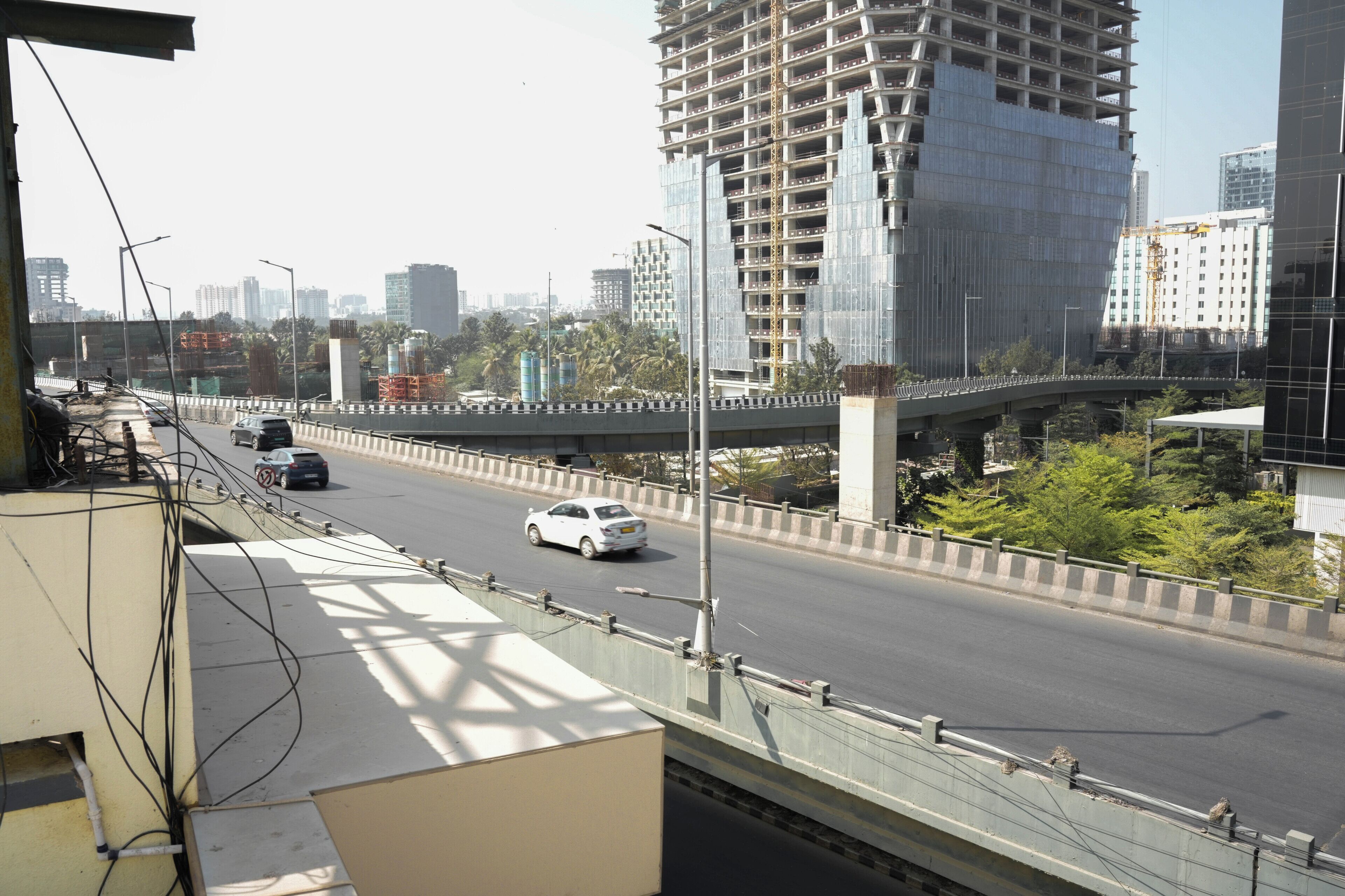 A multi-level highway with vehicles, a bridge, and a construction site with scaffolding.