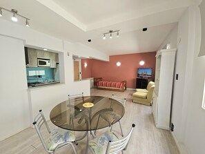A compact living space with a kitchen, dining area, and seating area. - Civic center Bariloche (San Carlos de Bariloche)