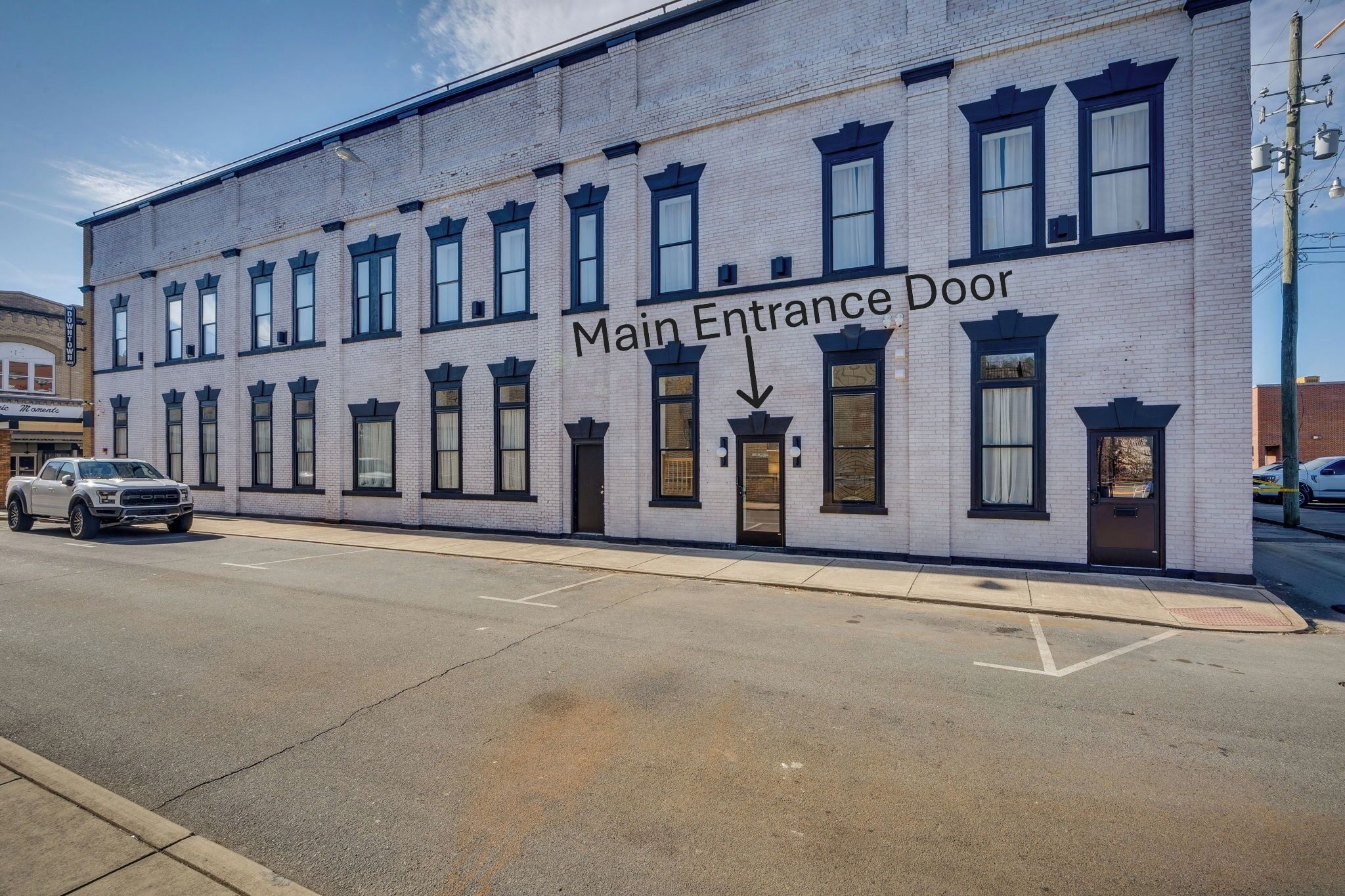 A multi-story building with a clearly marked main entrance door.
