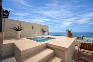 A rooftop terrace with a hot tub, steps leading to it, and a view of the ocean. - Above The Arch: Penthouse w/ Private Rooftop Pool (Cabo San Lucas)