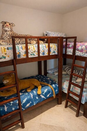 A bunk bed with a lion plush toy on the lower bunk. - The Beachhouse At Rancho Leonero (Los Cabos)