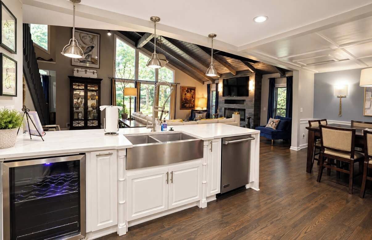 A spacious kitchen with a large island, built-in appliances, and a dining area with a wooden table and chairs.