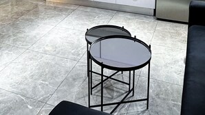 A modern kitchen with white cabinets, a stainless steel refrigerator, a microwave, and a sink. There is a small table with chairs in the foreground. - Charming two-bedroom apartment On The Sea Bat Yam (Bat Yam)