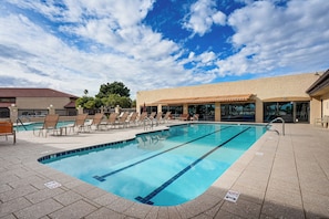 A swimming pool with lounge chairs and a building in the background. - Close to Golf! 55-Plus Snowbird Escape in Mesa (Mesa)