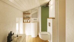 Un bany modern amb terra de fusta, un lavabo blanc, un vàter i una paret d'accent verd.
