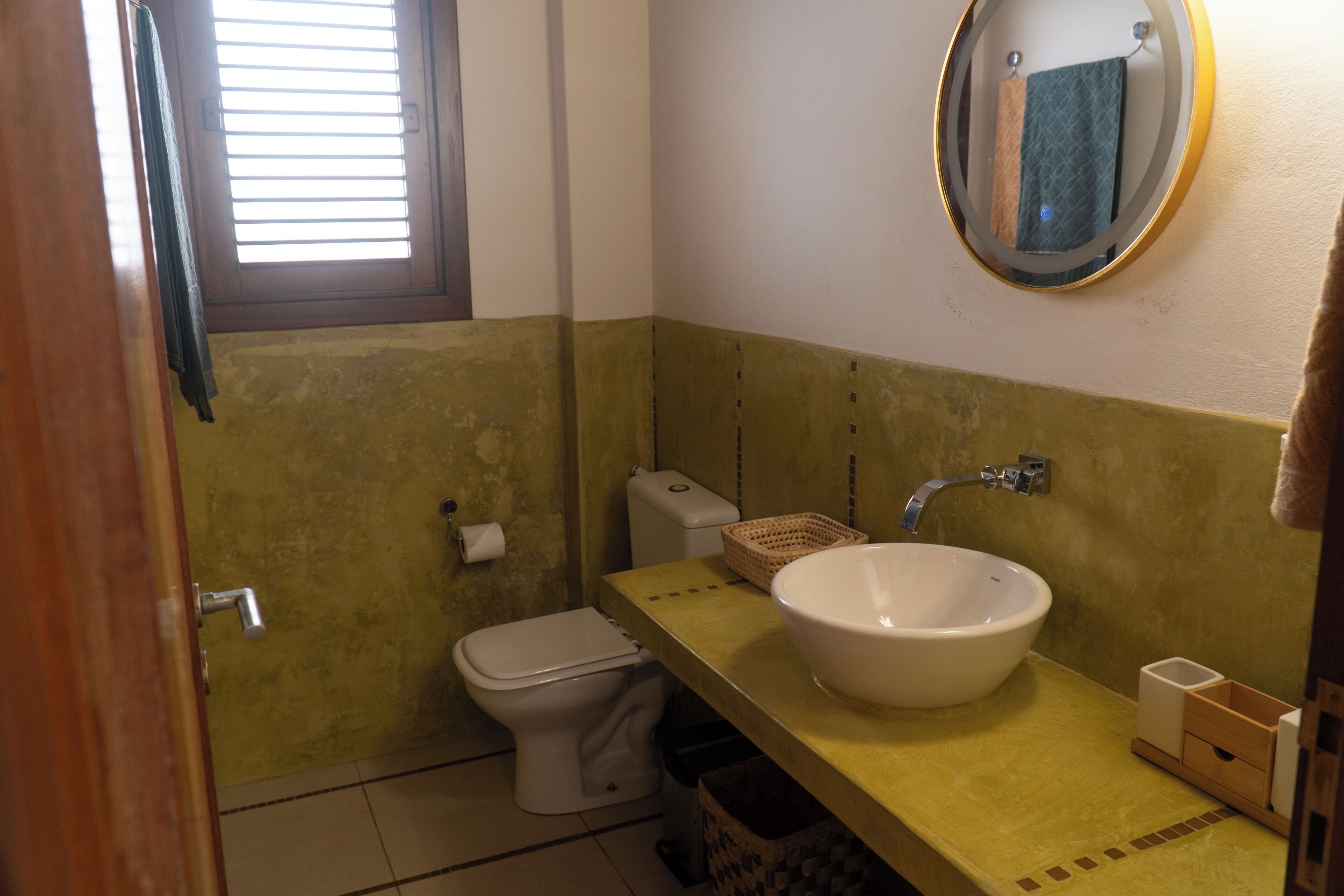 Un baño pequeño con inodoro, lavabo y espejo.