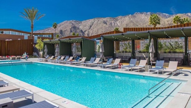 A pool area with lounge chairs and umbrellas, a clear blue pool, and a mountainous backdrop. - Charming 3BR Home in Union (Union)