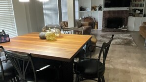 A dining area with a wooden table, black chairs, and decorative pumpkins. - Spacious 4-bedroom house with AC in fantastic Houston neighborhood (Houston)