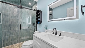 Shower, hair dryer, towels, shampoo