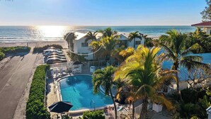 A resort with a swimming pool, beach access, and a view of the ocean. - New! Beachfront Paradise! ~Heated Pool! Top Floor (Holmes Beach)