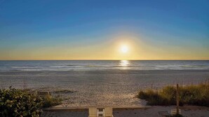 A beach with a wooden viewing platform and a sign indicating private property. - New! Beachfront Paradise! ~Heated Pool! Top Floor (Holmes Beach)