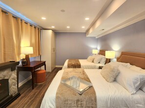 A hotel room with two beds, a desk, a chair, and a TV. - A Rather Posh 4 BR Renton Retreat with AC (Renton)